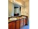 Bathroom featuring double vanity and tiled flooring at 25012 Chipshot Ct, Sorrento, FL 32776