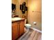 Cozy bathroom featuring dark granite vanity, a toilet, and decorative wall art at 25012 Chipshot Ct, Sorrento, FL 32776