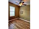 Bedroom featuring hardwood floors, a ceiling fan, and natural light at 25012 Chipshot Ct, Sorrento, FL 32776