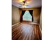 Bedroom featuring wood-look flooring and a window with dark curtains at 25012 Chipshot Ct, Sorrento, FL 32776