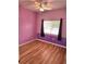 Cozy bedroom featuring hardwood floors, a ceiling fan and a window providing natural light at 25012 Chipshot Ct, Sorrento, FL 32776