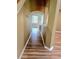 Hallway with archway, wooden floors, and natural light from the nearby window at 25012 Chipshot Ct, Sorrento, FL 32776