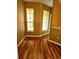 Hallway with hardwood floors and natural light streaming through the windows at 25012 Chipshot Ct, Sorrento, FL 32776