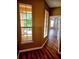 Upstairs hallway featuring wood-look flooring, natural light, and views through large windows at 25012 Chipshot Ct, Sorrento, FL 32776