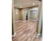 Spacious living room with light brown wood flooring and neutral-toned walls with an open entry at 25012 Chipshot Ct, Sorrento, FL 32776