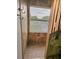 Tile shower with patterned glass window at 25012 Chipshot Ct, Sorrento, FL 32776