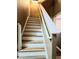 Well-lit staircase with white railings and wood-look flooring, offering easy access to upper floors at 25012 Chipshot Ct, Sorrento, FL 32776