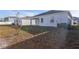 Spacious backyard with grass and partial view of the home's exterior, ready for outdoor activities and relaxation at 2750 Slash Way, St Cloud, FL 34771
