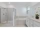 Modern bathroom features a glass-enclosed shower, a soaking tub, and dual vanities at 2750 Slash Way, St Cloud, FL 34771