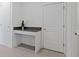 Bright desk nook, adjacent to a door and next to a cabinet, features clean white surfaces and a dark grey countertop at 2750 Slash Way, St Cloud, FL 34771