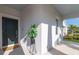Inviting front porch with stylish black door and decorative plant welcomes guests into a charming, modern home at 2750 Slash Way, St Cloud, FL 34771