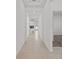 Long hallway with light tile floors offers a glimpse into other rooms, enhancing the sense of space and flow at 2750 Slash Way, St Cloud, FL 34771