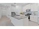 Modern kitchen with white cabinets, stainless steel appliances, and a large center island at 2750 Slash Way, St Cloud, FL 34771