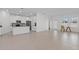 Spacious living area connecting to the kitchen, featuring modern tile flooring and lots of natural light at 2750 Slash Way, St Cloud, FL 34771