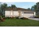 Inviting single-story home with a two-car garage, stone accents, and beautifully landscaped front yard at 305 Castle Dr, Lake Alfred, FL 33850