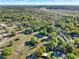Expansive aerial view showcasing a rural property with lush greenery and proximity to a major highway at 31024 Prestwick Ave, Sorrento, FL 32776