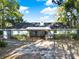 Back exterior with a covered patio, perfect for outdoor dining, and lots of space at 31024 Prestwick Ave, Sorrento, FL 32776