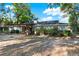 Back of home with a covered patio and mature landscaping, great for enjoying the outdoors at 31024 Prestwick Ave, Sorrento, FL 32776