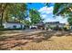 Spacious backyard featuring a covered patio area perfect for outdoor entertaining, with an additional building at 31024 Prestwick Ave, Sorrento, FL 32776