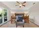 Bedroom with a carved wood headboard, plush chair, and bright window at 31024 Prestwick Ave, Sorrento, FL 32776