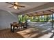 Backyard covered deck featuring outdoor kitchen and dining set, perfect for entertaining at 31024 Prestwick Ave, Sorrento, FL 32776