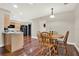 Bright dining area with wood table and chairs next to a kitchen with stainless steel appliances at 31024 Prestwick Ave, Sorrento, FL 32776