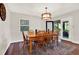 Dining room with wood table and chairs, decorative light fixture, and a sliding glass door to the patio at 31024 Prestwick Ave, Sorrento, FL 32776