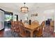 Sunlit dining room with a view into a living room and an outdoor patio through a sliding glass door at 31024 Prestwick Ave, Sorrento, FL 32776