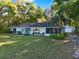 Lovely home with a spacious lawn, screened porch, and a detached garage, nestled among trees at 31024 Prestwick Ave, Sorrento, FL 32776