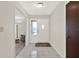 Bright foyer featuring tiled floors, a front door with sidelight, and a glimpse into the living area at 31024 Prestwick Ave, Sorrento, FL 32776