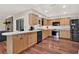 Spacious kitchen with light wood cabinetry, modern appliances, and a large island counter at 31024 Prestwick Ave, Sorrento, FL 32776