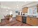 Kitchen view showcases wood cabinets, stainless appliances, an eat-in kitchen and view into a living room at 31024 Prestwick Ave, Sorrento, FL 32776