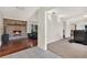 Open-concept living area showcasing a brick fireplace, hardwood floors, and seamless transitions to other living spaces at 31024 Prestwick Ave, Sorrento, FL 32776