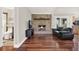 Inviting living room with a brick fireplace, hardwood floors, and an adjacent bathroom at 31024 Prestwick Ave, Sorrento, FL 32776