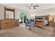 Comfortable main bedroom showcases stylish furniture, a soothing color scheme, and a large window at 31024 Prestwick Ave, Sorrento, FL 32776