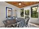 Relax and entertain in this screened porch with views of trees through the windows at 31024 Prestwick Ave, Sorrento, FL 32776