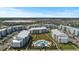 Aerial view of condo community featuring a pool, landscaping, and spacious parking and manicured landscaping at 3121 Paradox Cir # 307, Kissimmee, FL 34746