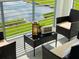 Close-up of outdoor table on balcony with decorative greenery and views of pond at 3121 Paradox Cir # 307, Kissimmee, FL 34746