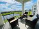 Balcony with beautiful views of community pond and modern outdoor furniture at 3121 Paradox Cir # 307, Kissimmee, FL 34746