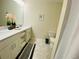 Bathroom with double sink vanity, fresh flowers, framed art and tile floors and shower at 3121 Paradox Cir # 307, Kissimmee, FL 34746