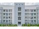 Three-story building with white facade and balconies, with easy access to community a/c units at 3121 Paradox Cir # 307, Kissimmee, FL 34746