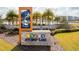 Beautifully landscaped Storey Lake community entrance with stone signage, mature palms, and manicured lawns at 3121 Paradox Cir # 307, Kissimmee, FL 34746