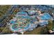 Aerial view of an elaborate community pool with waterslides, lazy river, mini golf and other water features at 3121 Paradox Cir # 307, Kissimmee, FL 34746