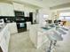 Modern kitchen features stainless steel appliances, island with seating, and tile backsplash and flooring at 3121 Paradox Cir # 307, Kissimmee, FL 34746