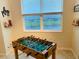 Bright and cheerful playroom featuring a Foosball table, and a view from two large windows at 3121 Paradox Cir # 307, Kissimmee, FL 34746