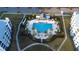 Aerial view of the community pool and lounge area, surrounded by palm trees and green lawns at 3121 Paradox Cir # 307, Kissimmee, FL 34746