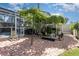 Backyard view featuring a stone patio, lush foliage and plants, shaded pergola, and access to the home at 3244 Amaca Cir, Orlando, FL 32837