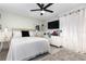 Bright bedroom features a ceiling fan and white curtains at 3244 Amaca Cir, Orlando, FL 32837