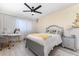 Charming bedroom features a ceiling fan, a desk, and a sunflower motif at 3244 Amaca Cir, Orlando, FL 32837