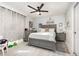 Comfortable bedroom with ceiling fan, drawers, and white tile flooring at 3244 Amaca Cir, Orlando, FL 32837